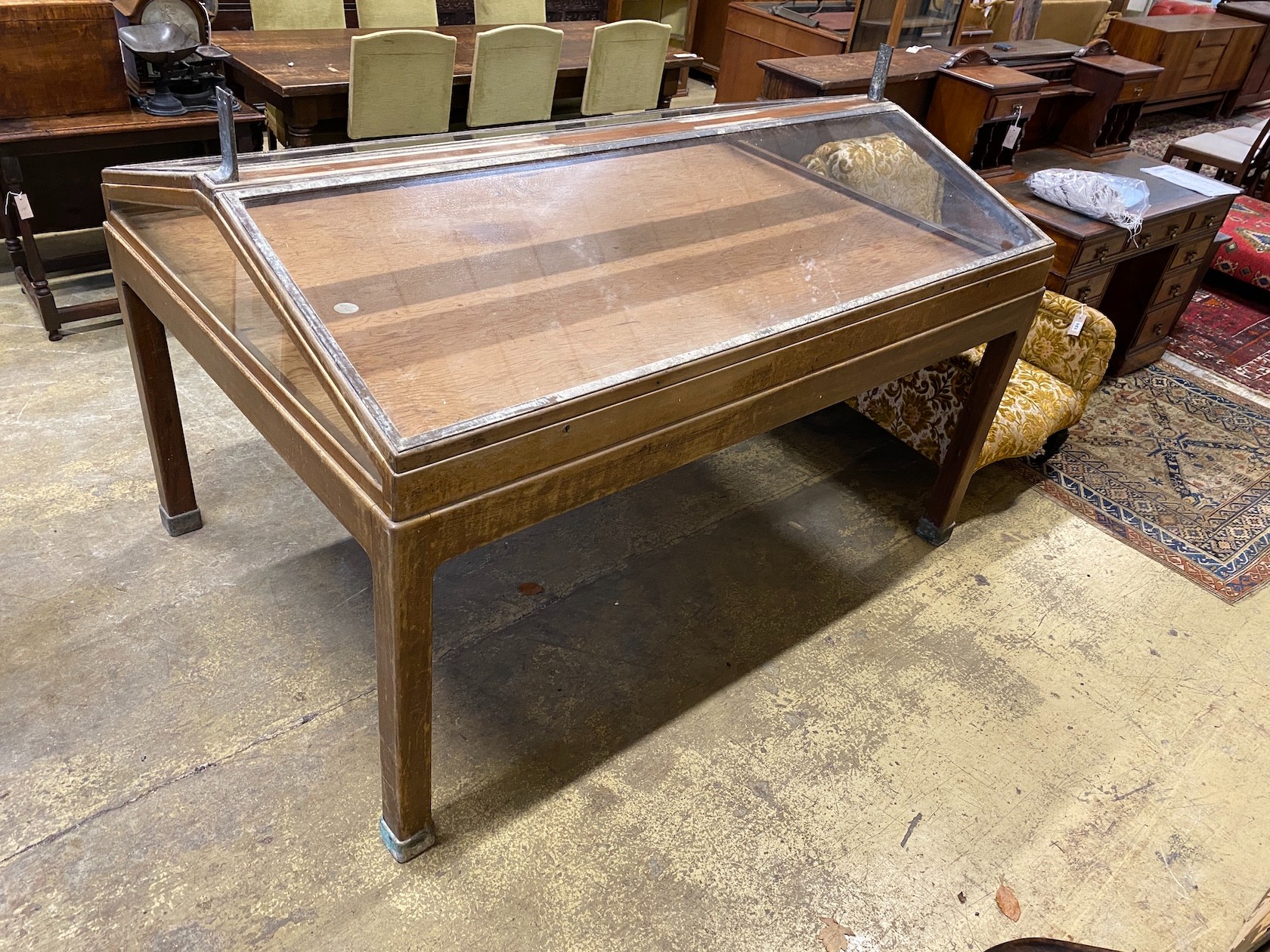 A mid century brass mounted mahogany museum specimen display cabinet with twin hinged slant top, width 184cm, depth 123cm.